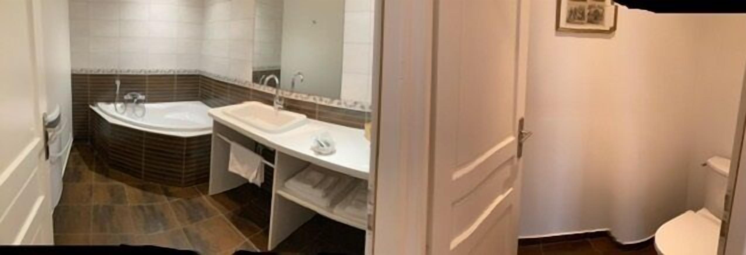 A bathroom with a bathtub, a sink, and a toilet.
