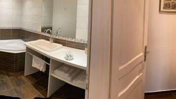 A bathroom with a bathtub, a sink, and a toilet.