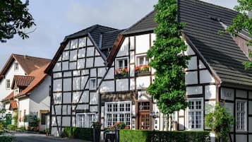 A traditional half-timbered building with a sign indicating it is a hotel.