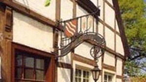 A traditional half-timbered house with a visible window, a door, and a small porch area. - Hotel Restaurant Alt Vellern (Beckum)