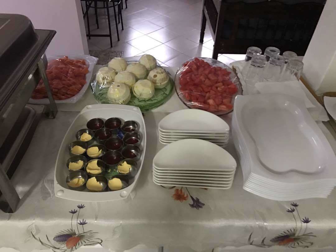 A buffet table with various food items and serving dishes.
