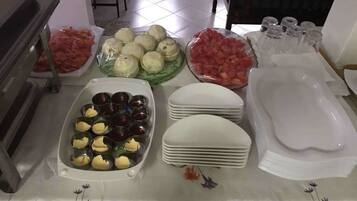 A buffet table with various food items and serving dishes.