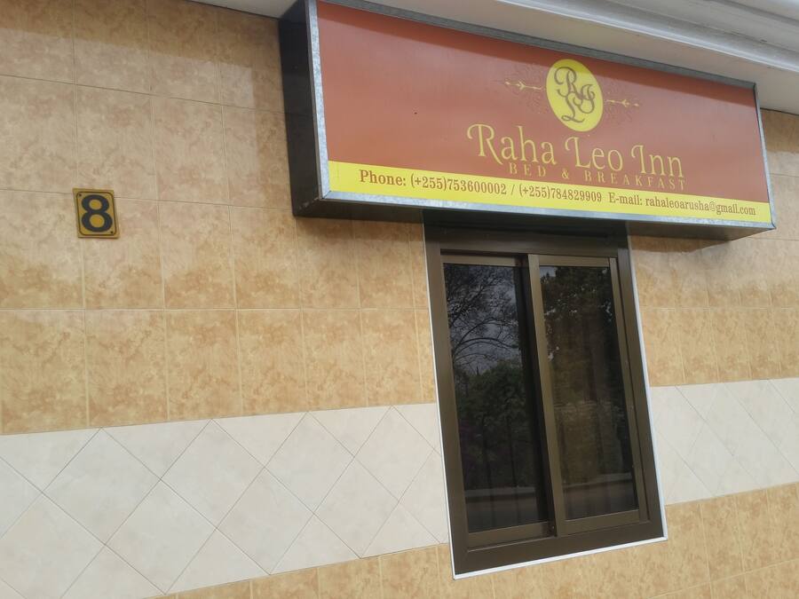 Señal del Raha Leo Inn con información de contacto.