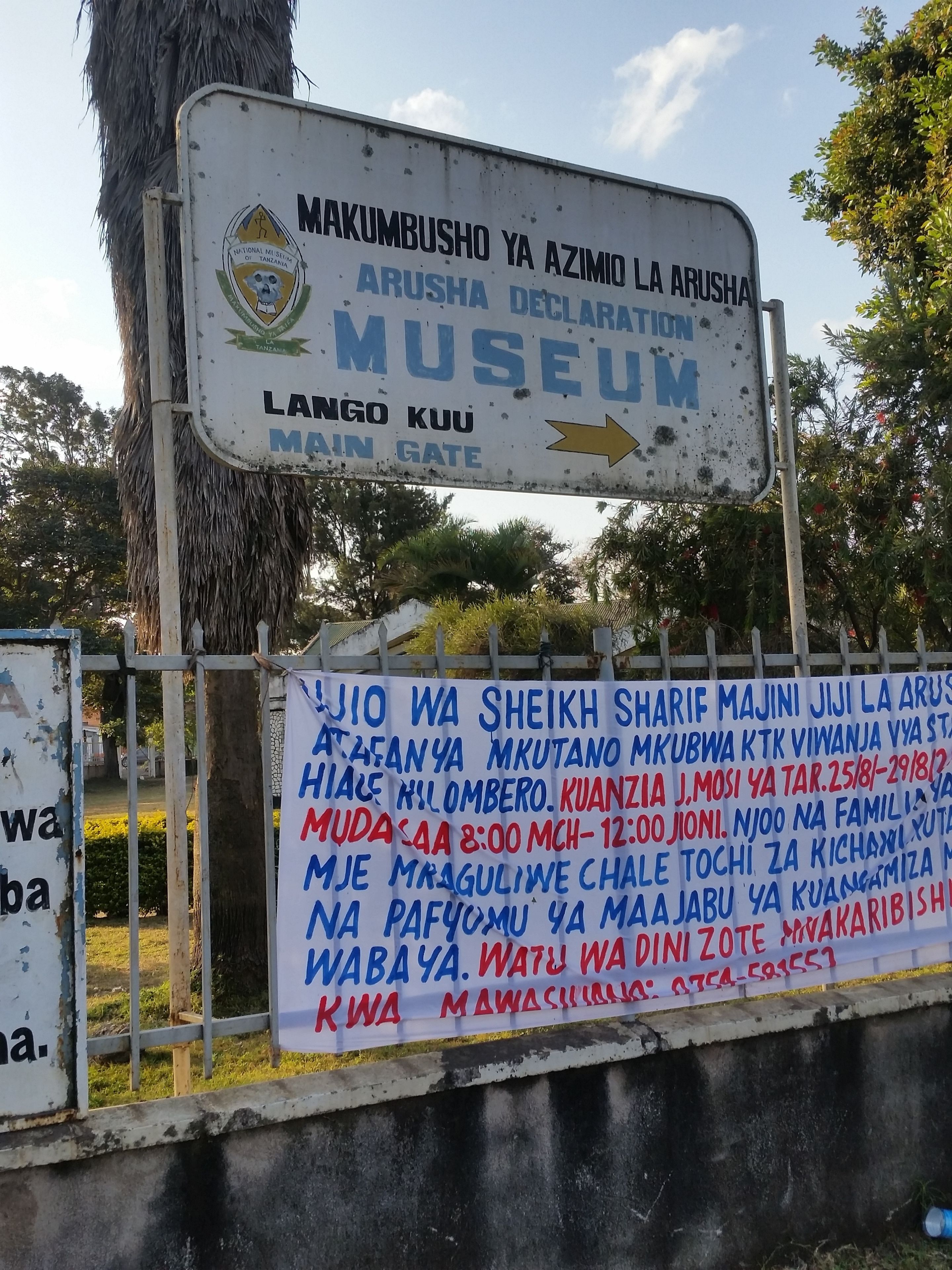 A sign for the Arusha Declaration Museum with a main gate direction.