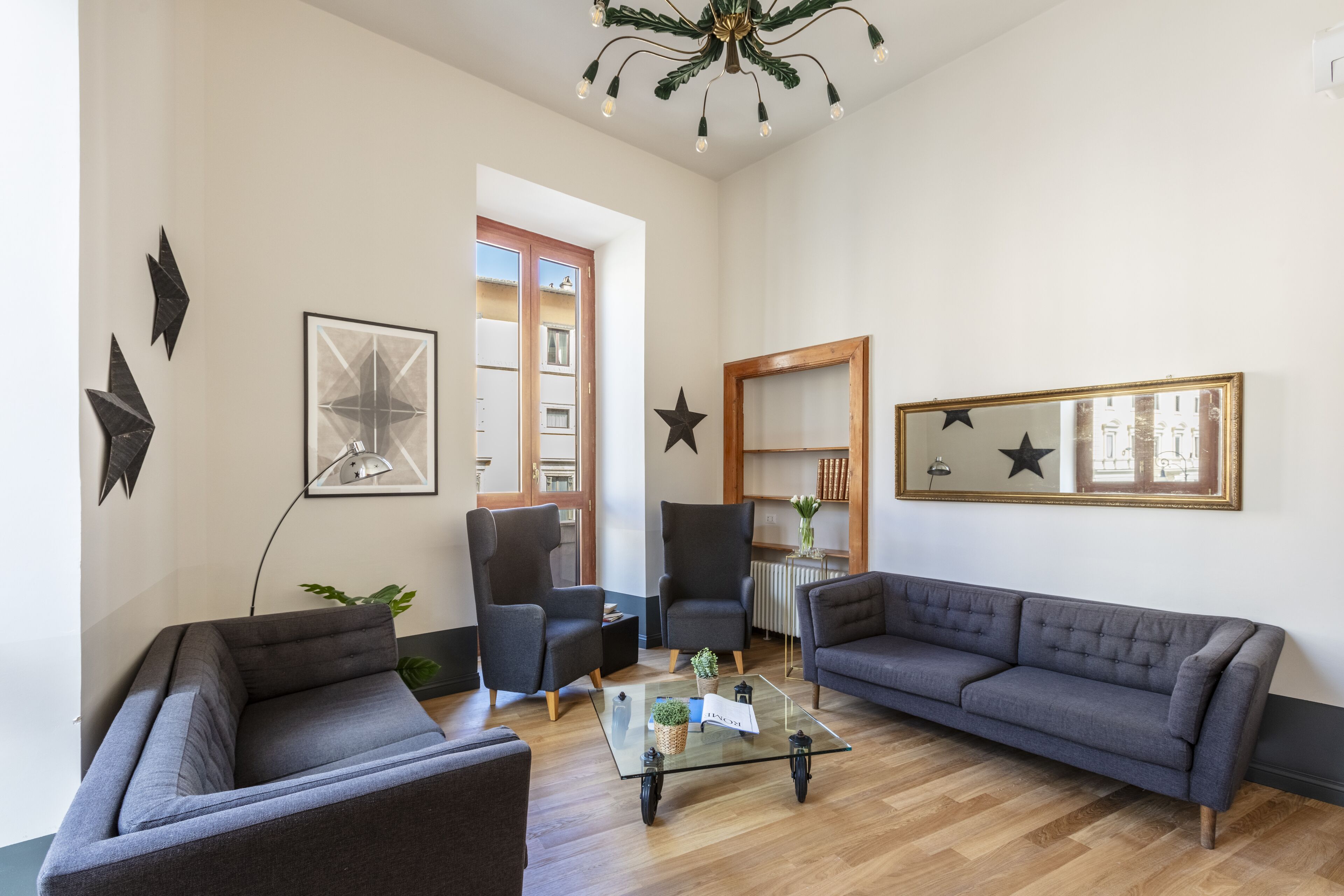 A modern living room with two sofas, a coffee table, and a bookshelf.