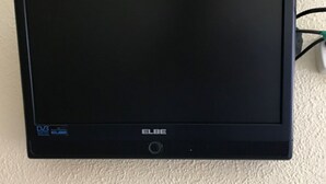 A flat-screen ELBE TV mounted on a wall.