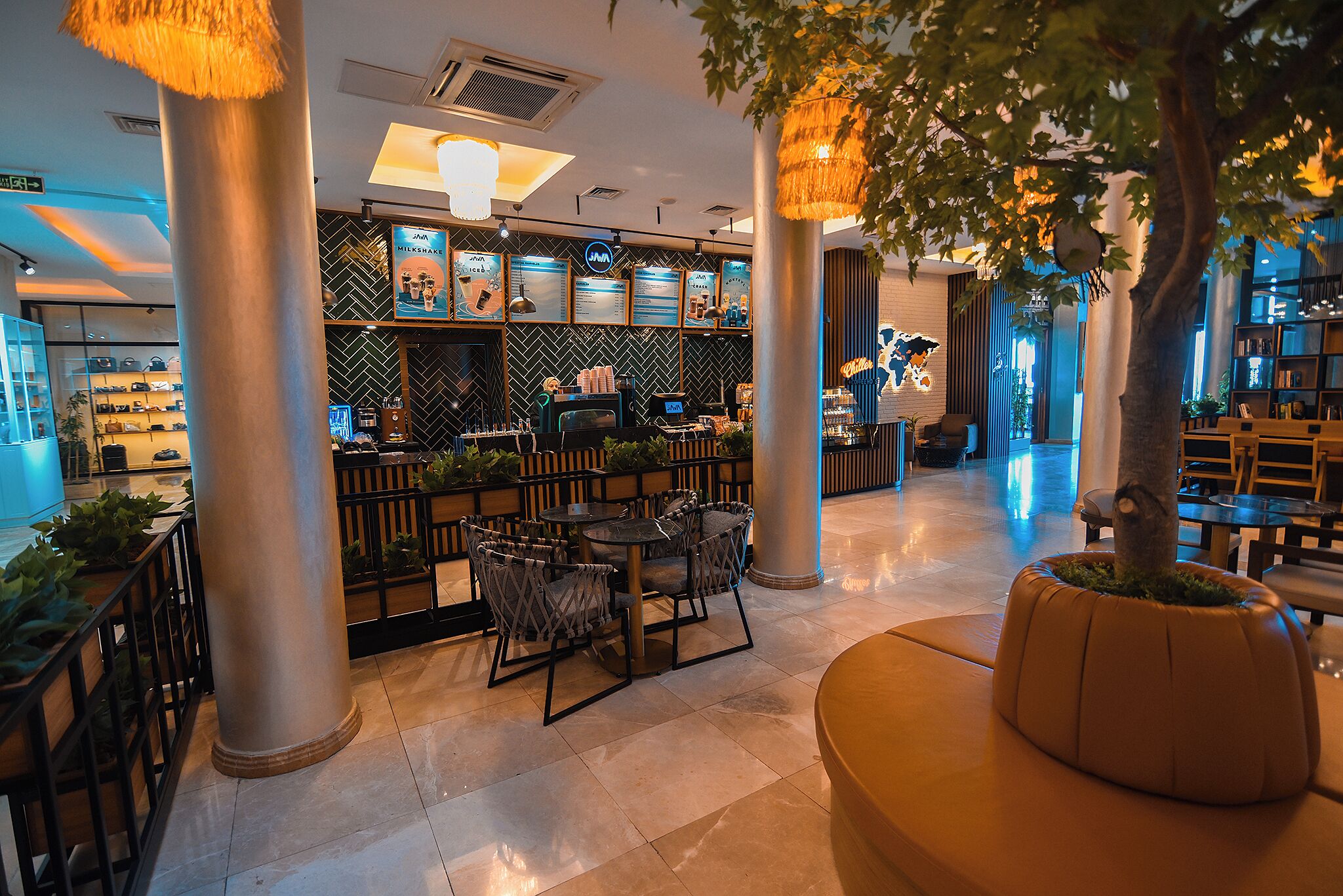 A modern indoor space with a seating area, a bar, and a display of various items.