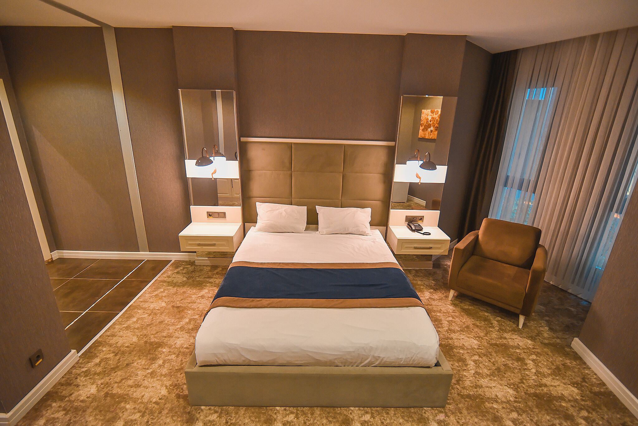 economy room | minibar, in-room safe, desk, blackout curtains