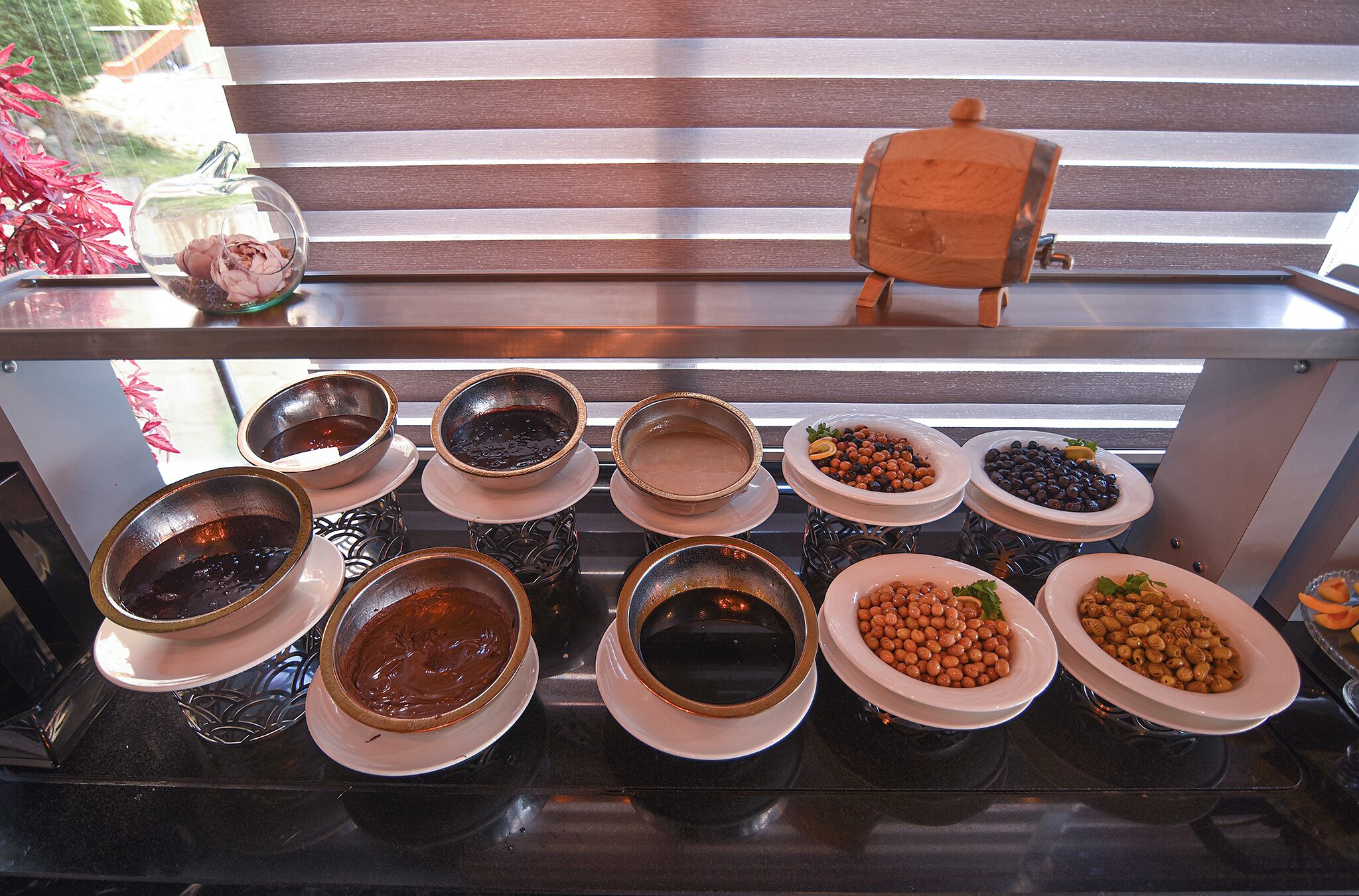 A buffet table with various dishes including bowls of soup, beans, and other foods.
