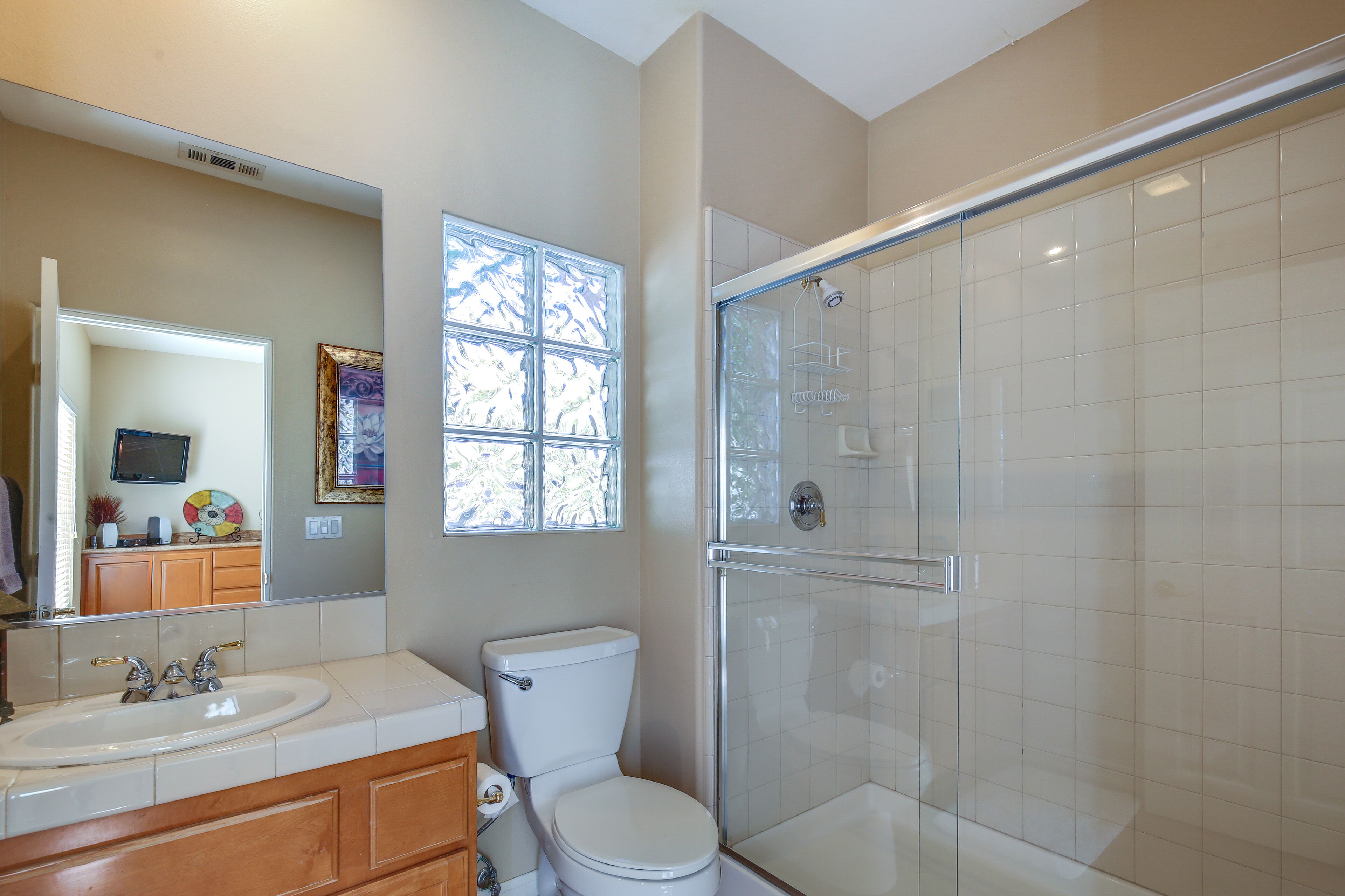 A bathroom with a toilet, sink, and shower.