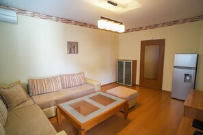 Cozy living space with a sofa set, ottoman, and coffee table.