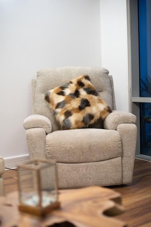 Relax in a cozy room with a plush armchair and a minimalist aesthetic.