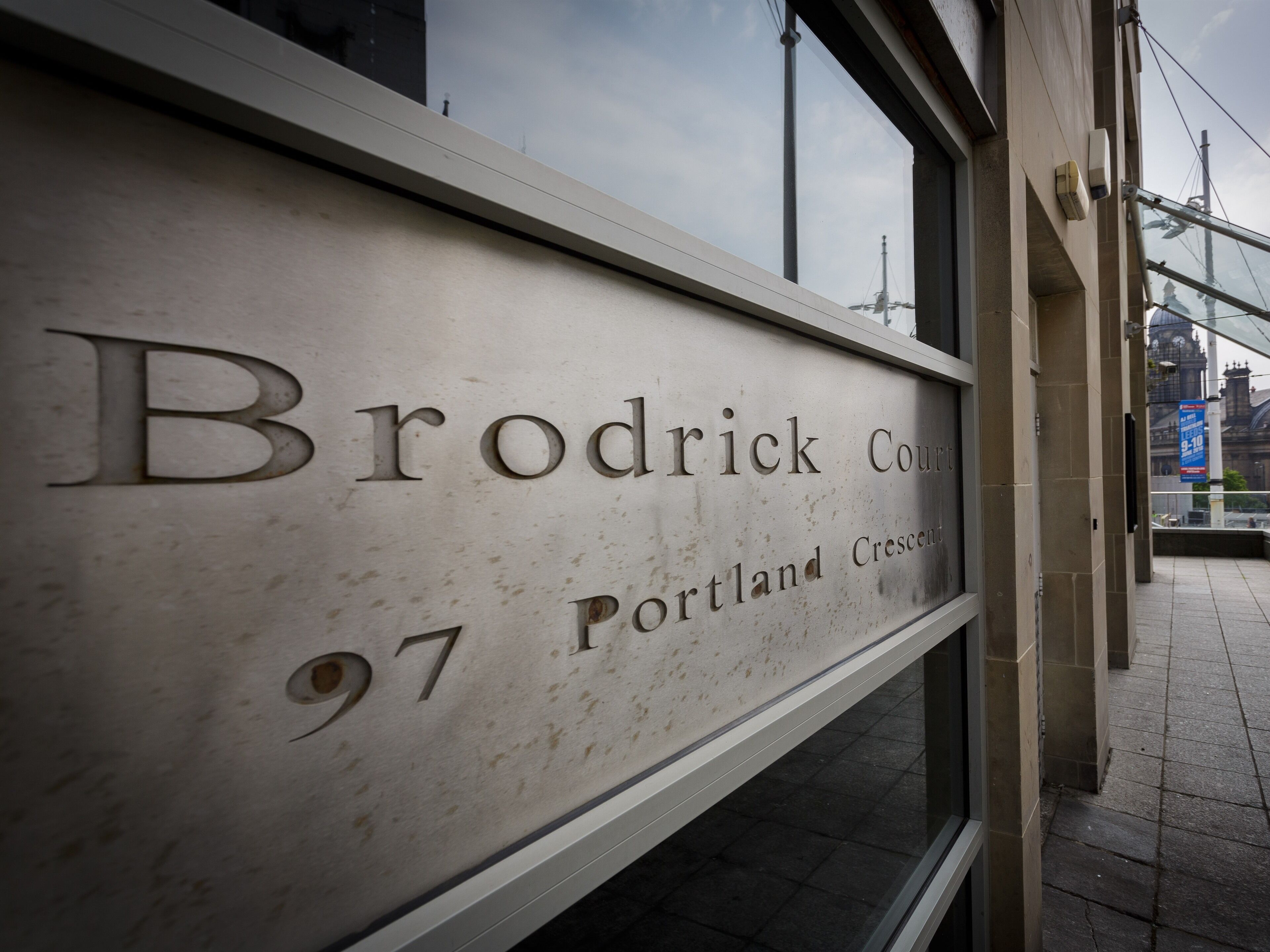 A sign with the text "Brodrick Court Portland Crescent 97".