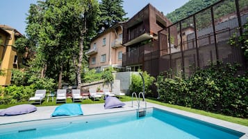 Seasonal outdoor pool, open 8:00 AM to 7:00 PM, pool umbrellas