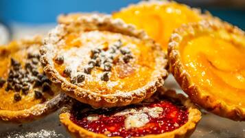 A close-up of various pies with different toppings.