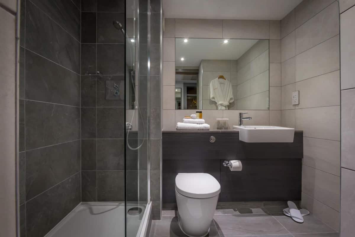 eco-friendly toiletries, hair dryer, slippers, towels