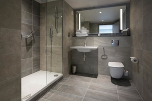 Eco-friendly toiletries, hair dryer, slippers, towels