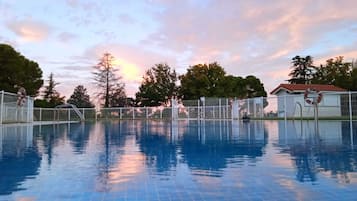 Seasonal outdoor pool, open 10:00 AM to 9:00 PM, pool loungers