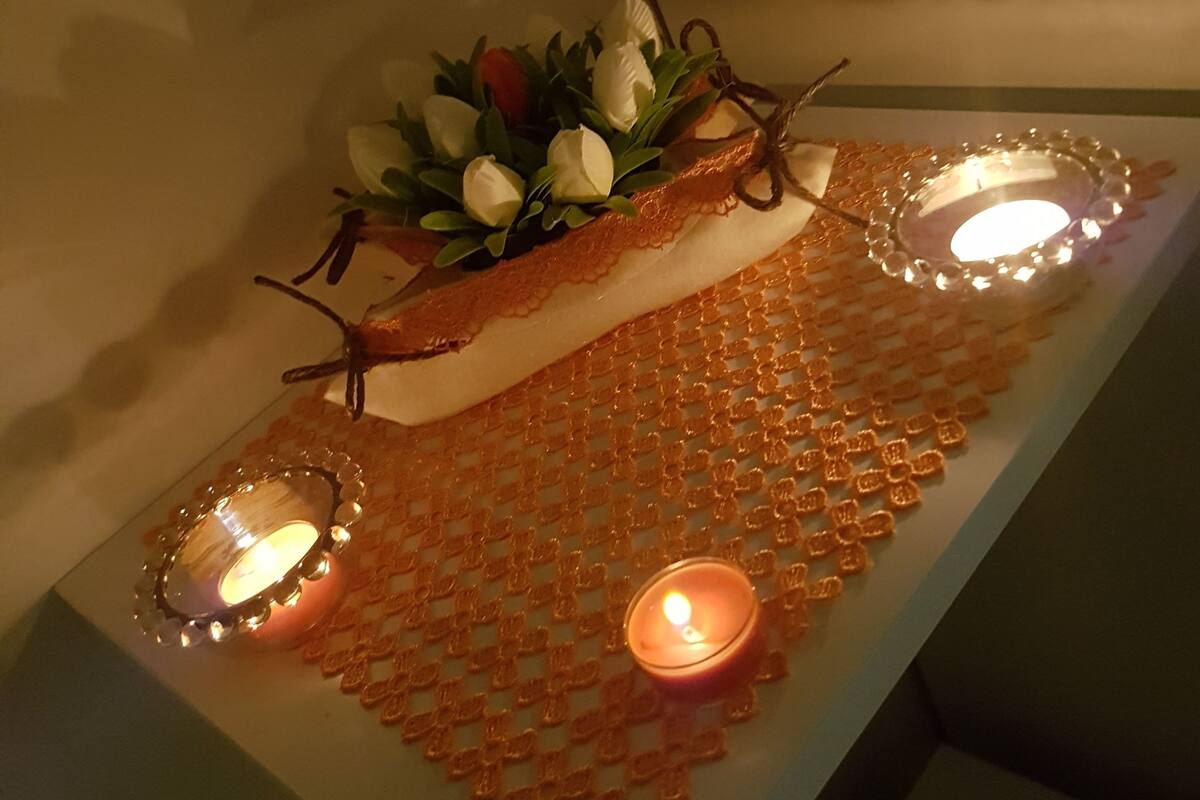 A decorative table with a floral arrangement and candles.