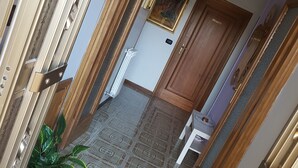 A hallway with patterned floor tiles, a potted plant, and a door labeled "PRIVATE". - B&B Dolce Casa (Castiglione del Lago)