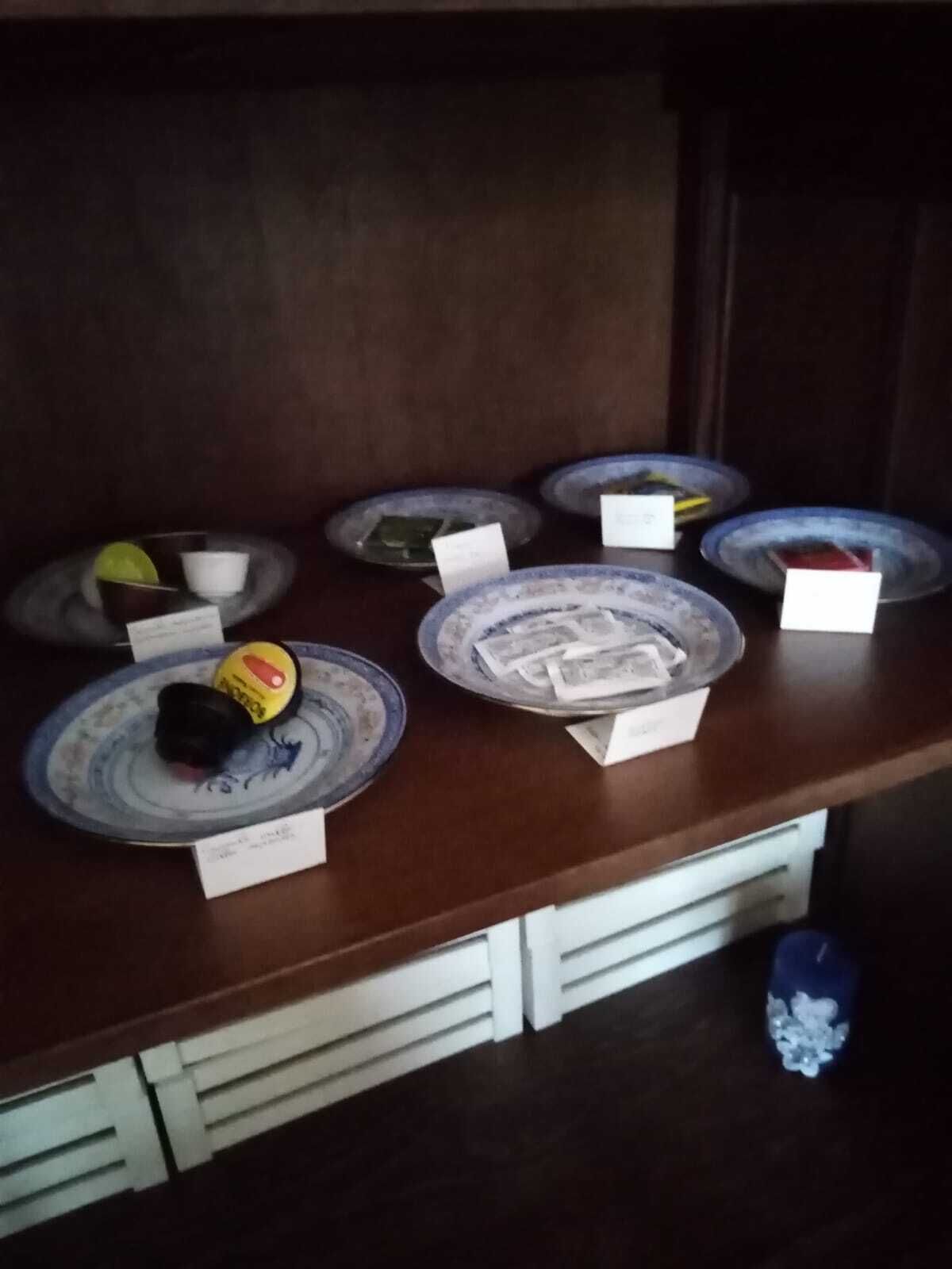 A buffet table with various dishes and condiments.