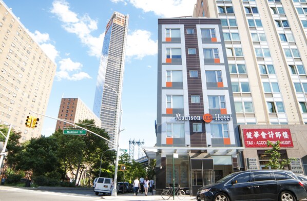 A hotel with a modern facade, located at the corner of a street. - Madison LES Hotel (New York)