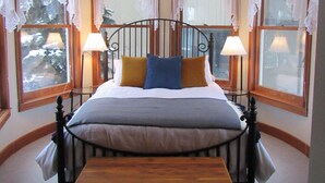 A bedroom with a four-poster bed, two bedside lamps, and a chandelier. - Breckenridge Vacation Home For Rent within walking distance to all amenities (Breckenridge)