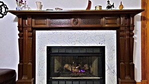 A fireplace with a marble surround, a mantel with decorative items, and a screen door. - Breckenridge Vacation Home For Rent within walking distance to all amenities (Breckenridge)