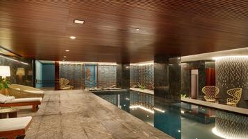 Relax by the pool in a serene atmosphere, surrounded by lounge chairs and elegant decor.