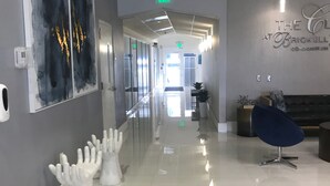 A modern hallway with a glass door, a reception desk, and a sign indicating 'EXIT'. - Stay at Brickell by Executive Corporate Rental (Miami)