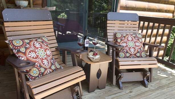 Two wooden rocking chairs with patterned cushions on a wooden deck, a bottle of wine, and a small table with snacks. - Lazy Bear Lodge (Vilas)