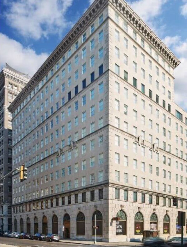 A large, multi-story hotel with a symmetrical facade, numerous windows, and a central entrance with arched doorways.