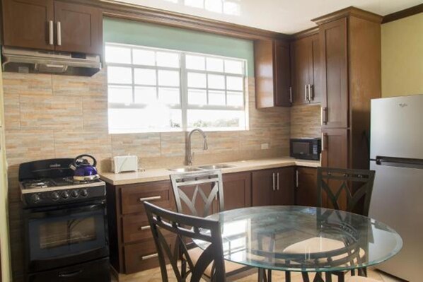 Comfort Apartment, 2 Bedrooms | Private kitchen | Fridge, microwave, stovetop, coffee/tea maker - Believe Caribbean Apartments (Bridgetown)