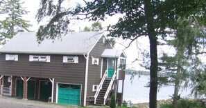 A two-story building with a private entrance to an attached apartment, featuring a green door and a stairway. - "Tranquility Base" is a place where you can lose yourself in nature. (St George)