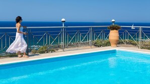 A pool with a clear view of the ocean, a person in a white dress, and a large potted plant. - Amazing Sea View villa w/pool, close to Elafonissi (Livadia)