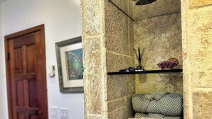 A stone wall with a shelf holding decorative items and a cushion. - Hamilton Cove ocean front luxury Villa Spectacular Views w/electric cart (Avalon)