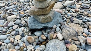 A stack of stones on a pebbly beach with the ocean in the background. - Hamilton Cove ocean front luxury Villa Spectacular Views w/electric cart (Avalon)