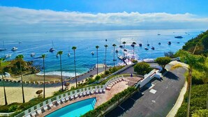 A resort with a pool, beach, and ocean view. - Amazing Luxury ocean front Hamilton Cove Villa  w/electric cart (Avalon)