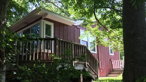 A two-story house with a wooden deck and a staircase leading to the front door. - River's Edge Cabin - Swim - Kayak - Fish From Your Backyard !!!! (Franklin)