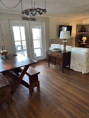 Enjoy a meal at the large dining table in this spacious room with a view of the outdoors.