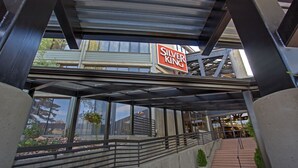 A modern building with a sign reading "Silver King" and a covered outdoor area with steps leading to a building entrance. - Highly Rated Silver King - Steps to Skiing - 2BD/2BA (Park City)