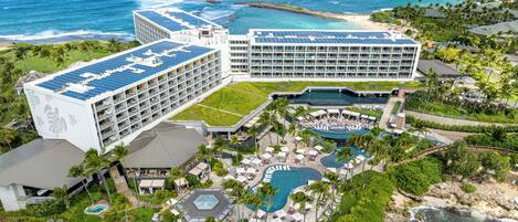 A resort with multiple buildings, a pool area, and a beach.
