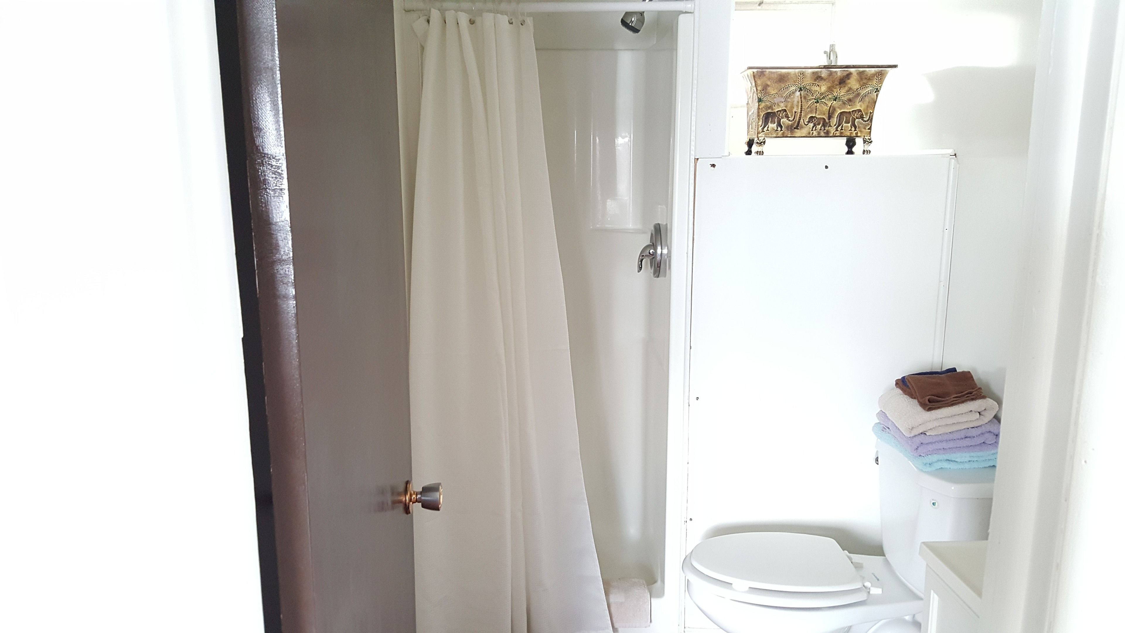 A bathroom with a toilet, a sink, and a shower curtain.
