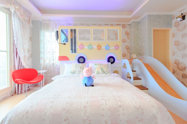 A child's bedroom with a bed, a red chair, a toy, and a wall decorated with clocks. - Elegance House (Wujie)