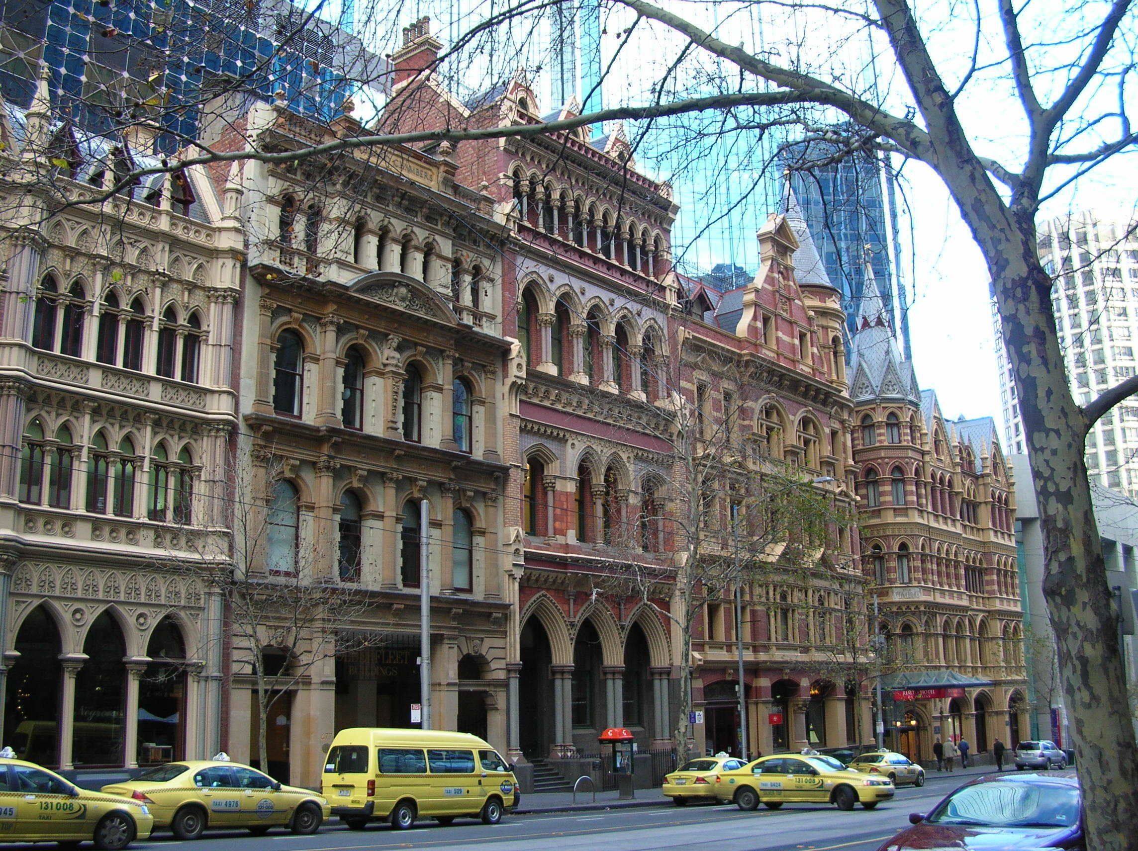 A historic building with ornate architecture, including arched windows and detailed stonework.