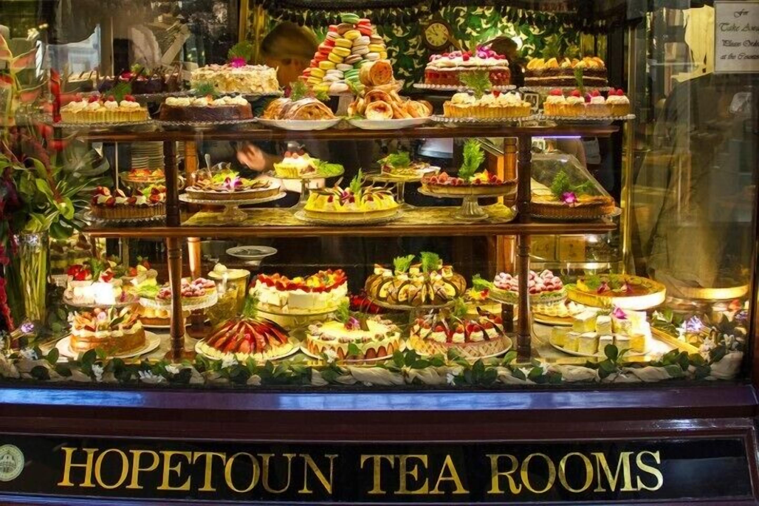 A display of various desserts in a glass case at Hopetown Tea Rooms.