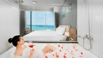 Relax in style with a bathtub filled with water and rose petals, and enjoy a glass of wine while taking in the ocean view.