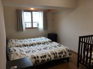 Apartment, 2 Bedrooms | 2 bedrooms, free cots/infant beds - Ganesha (Yomitan)