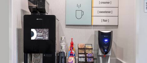 A coffee machine with a digital display, a creamer dispenser, a sweetener dispenser, and a scale for measuring coffee grounds.