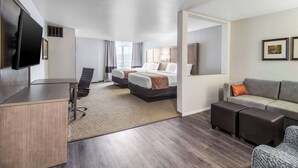 A hotel room with a desk, two beds, a sofa, and a TV. - Comfort Suites Columbia I-65 (Columbia)